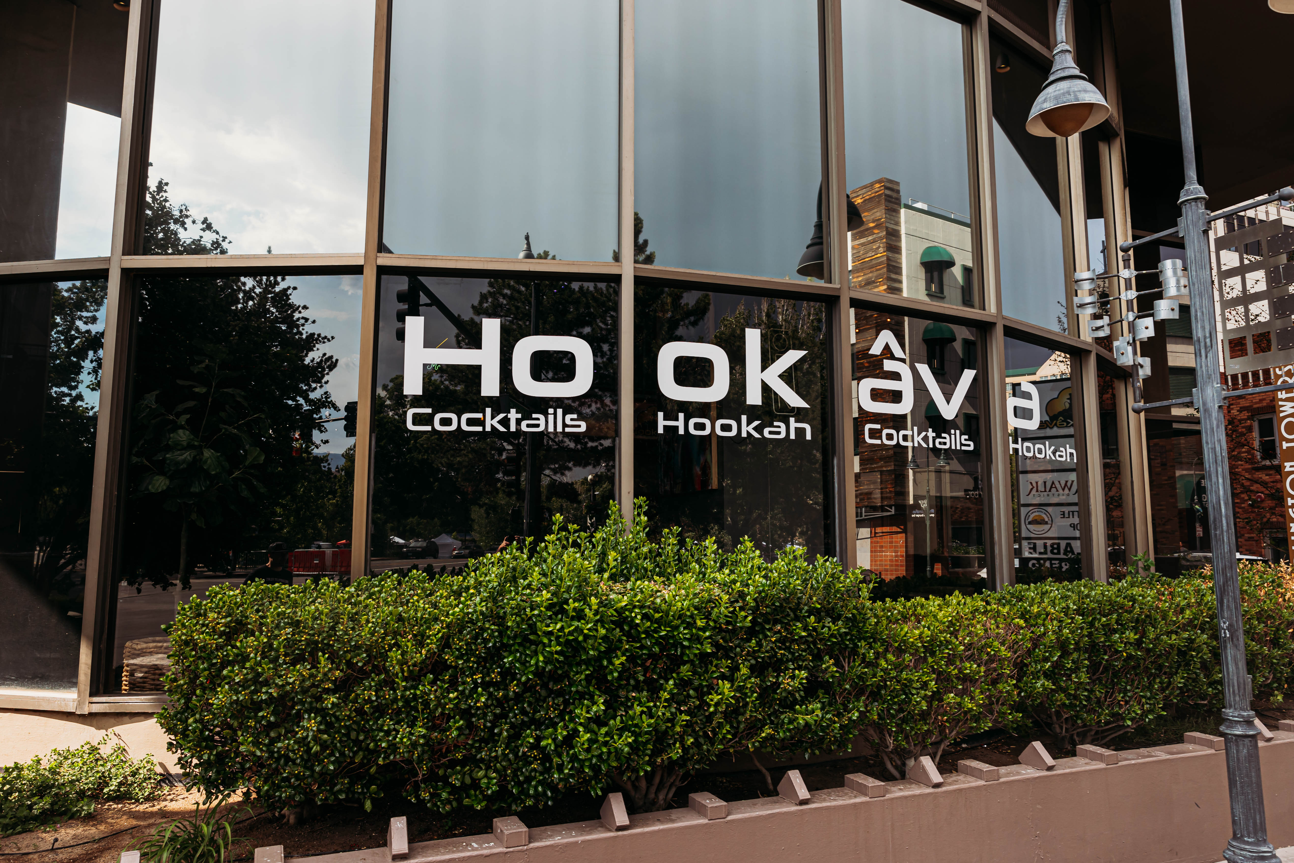 Hookava interior — art wall with mural, string lights, and lounge seating
